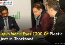 Welspun World Eyes ₹300 Cr Plastic Project in Jharkhand Business leaders in a formal meeting discussing Welspun World’s ₹300 crore plastic project in Jharkhand, with documents on the table and a branded backdrop in the background.