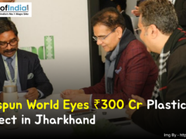 Business leaders in a formal meeting discussing Welspun World’s ₹300 crore plastic project in Jharkhand, with documents on the table and a branded backdrop in the background.