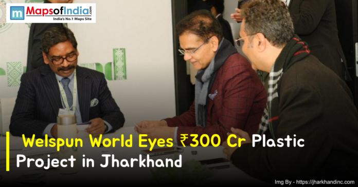 Business leaders in a formal meeting discussing Welspun World’s ₹300 crore plastic project in Jharkhand, with documents on the table and a branded backdrop in the background.
