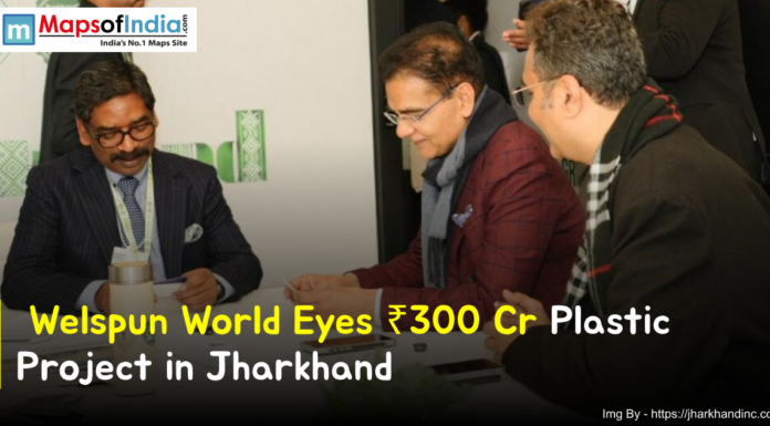 Welspun World Eyes ₹300 Cr Plastic Project in Jharkhand Business leaders in a formal meeting discussing Welspun World’s ₹300 crore plastic project in Jharkhand, with documents on the table and a branded backdrop in the background.