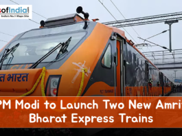 Front view of an orange Amrit Bharat Express train decorated with marigold garlands at a railway station, featuring the headline “PM Modi to Launch Two New Amrit Bharat Express Trains.”