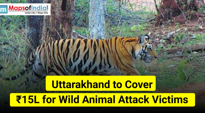 Uttarakhand to Cover ₹15L for Wild Animal Attack Victims A tiger walking through a forest in Uttarakhand with text stating “Uttarakhand to Cover ₹15L for Wild Animal Attack Victims” and the Maps of India logo.