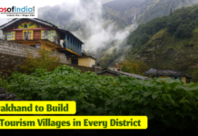 Uttarakhand to Build Two Tourism Villages in Every District Scenic mountain village in Uttarakhand with traditional houses, lush green vegetation, and mist-covered hills, featuring a headline that reads ‘Uttarakhand to Build Two Tourism Villages in Every District.’