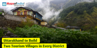 Uttarakhand to Build Two Tourism Villages in Every District Scenic mountain village in Uttarakhand with traditional houses, lush green vegetation, and mist-covered hills, featuring a headline that reads ‘Uttarakhand to Build Two Tourism Villages in Every District.’