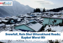 Snowfall, Rain Shut Uttarakhand Roads; Kapkot Worst Hit Snow-covered houses in a mountain village with a text overlay reading "Snowfall, Rain Shut Uttarakhand Roads; Kapkot Worst Hit."