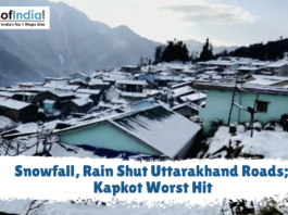 Snowfall, Rain Shut Uttarakhand Roads; Kapkot Worst Hit Snow-covered houses in a mountain village with a text overlay reading "Snowfall, Rain Shut Uttarakhand Roads; Kapkot Worst Hit."