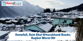 Snowfall, Rain Shut Uttarakhand Roads; Kapkot Worst Hit Snow-covered houses in a mountain village with a text overlay reading "Snowfall, Rain Shut Uttarakhand Roads; Kapkot Worst Hit."