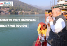 Amit Shah to Visit Haridwar on March 7 for Review Amit Shah offers prayers by the Ganga river in Haridwar, with text overlay announcing his visit on March 7 for a review