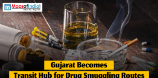Gujarat Becomes Transit Hub for Drug Smuggling Routes Still life showing syringes, pills, a cigarette in an ashtray, and a glass of liquid on a wooden table as a headline reports Gujarat becoming a transit hub for drug smuggling routes.