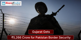 Gujarat Gets ₹5,266 Crore for Pakistan Border Security Silhouette of an armed Indian border security personnel standing near a barbed wire fence at sunset, with a headline overlay reading “Gujarat Gets ₹5,266 Crore for Pakistan Border Security” and Maps of India logo in the corner