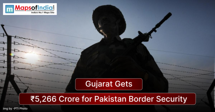 Silhouette of an armed Indian border security personnel standing near a barbed wire fence at sunset, with a headline overlay reading “Gujarat Gets ₹5,266 Crore for Pakistan Border Security” and Maps of India logo in the corner