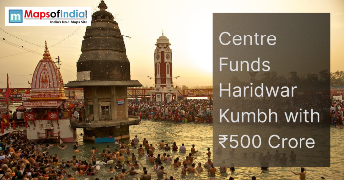 Devotees bathing in the Ganga at Haridwar during Kumbh Mela, with temples and clock tower in the background and text about ₹500 crore central funding