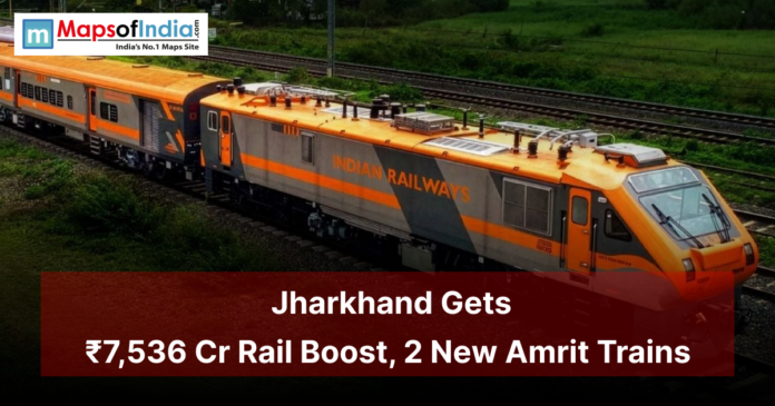 An Indian Railways orange train running on green countryside tracks with a banner reading “Jharkhand Gets ₹7,536 Cr Rail Boost, 2 New Amrit Trains,” highlighting major railway development in Jharkhand.