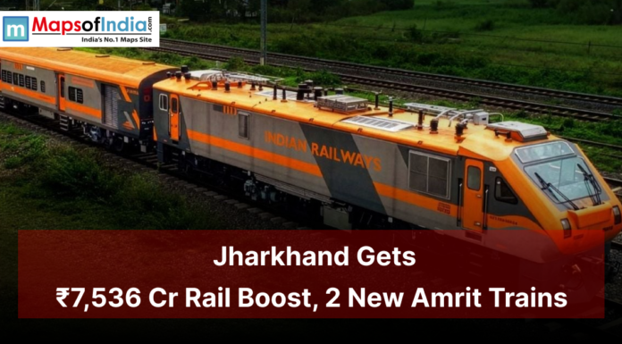 Jharkhand Gets ₹7,536 Cr Rail Boost, 2 New Amrit Trains An Indian Railways orange train running on green countryside tracks with a banner reading “Jharkhand Gets ₹7,536 Cr Rail Boost, 2 New Amrit Trains,” highlighting major railway development in Jharkhand.