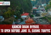 Kainchi Dham Bypass to Open Before June 15, Easing Traffic Aerial view of Kainchi Dham area in Uttarakhand showing a temple complex, bridge, hillside town, and traffic, with text announcing “Kainchi Dham Bypass to open before June 15, easing traffic”