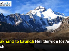 Snow-capped Adi Kailash peak in Uttarakhand under a clear blue sky with text overlay reading “Uttarakhand to Launch Heli Service for Adi Kailash” and Maps of India logo in the corner.