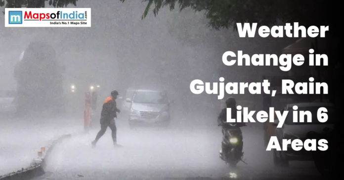 Heavy rainfall lashes a street in Gujarat as pedestrians and vehicles navigate low visibility conditions.