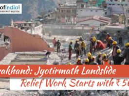 Rescue workers wearing helmets clear debris at a landslide-affected site in Jyotirmath, Uttarakhand, with damaged buildings in the background and headline about ₹500 crore relief work.