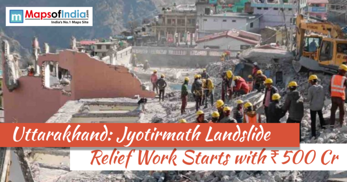 uttrakhand jyotimath Rescue workers wearing helmets clear debris at a landslide-affected site in Jyotirmath, Uttarakhand, with damaged buildings in the background and headline about ₹500 crore relief work.
