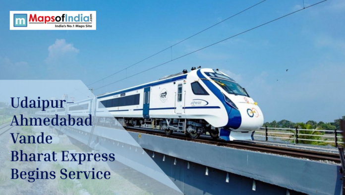 vande bharat Vande Bharat Express train running on an elevated track as Udaipur–Ahmedabad service begins, featured in a Maps of India graphic