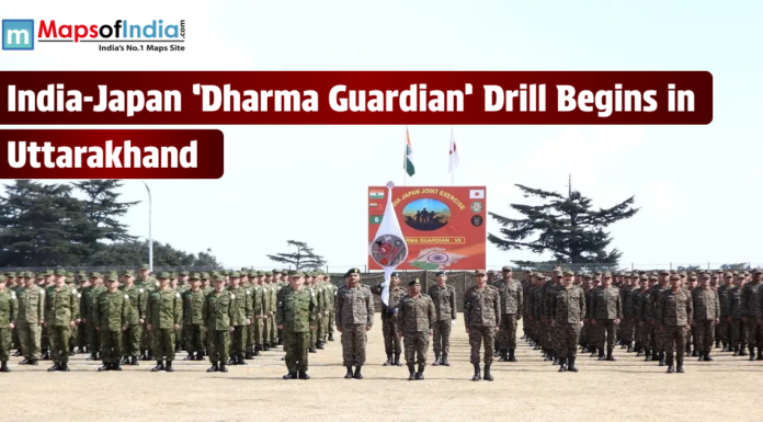 India-Japan ‘Dharma Guardian’ Drill Begins in Uttarakhand A group of Indian and Japanese soldiers standing in formation at an outdoor military grounds for the 'Dharma Guardian' joint exercise in Uttarakhand. A large banner and the national flags of India and Japan are visible in the background, with the Maps of India logo in the top left corner.