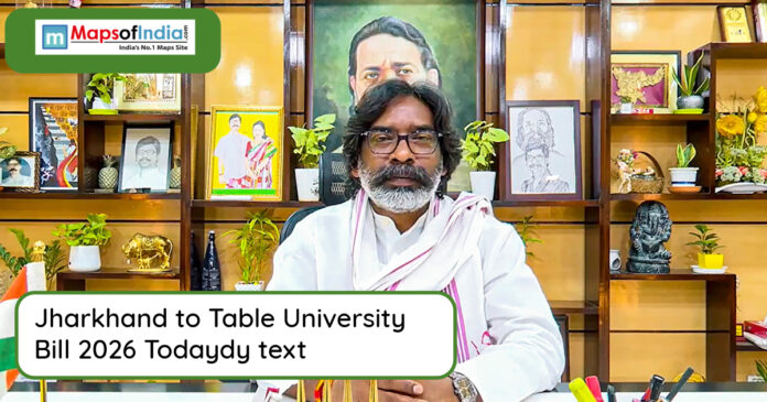 Man seated at a desk addressing media about Jharkhand University Bill 2026, with framed photos and decor in the background