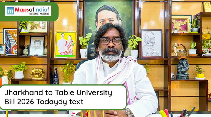 Jharkhand to Table University Bill 2026 Today Man seated at a desk addressing media about Jharkhand University Bill 2026, with framed photos and decor in the background
