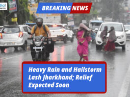 People and vehicles struggle on a rain-soaked road during heavy rainfall and hailstorm in Jharkhand.