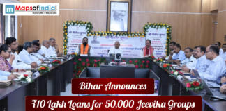 Bihar Announces ₹10 Lakh Loans for 50,000 Jeevika Groups Government meeting in Bihar where officials announce ₹10 lakh loans for 50,000 Jeevika groups, with a portrait of Mahatma Gandhi displayed in the background.