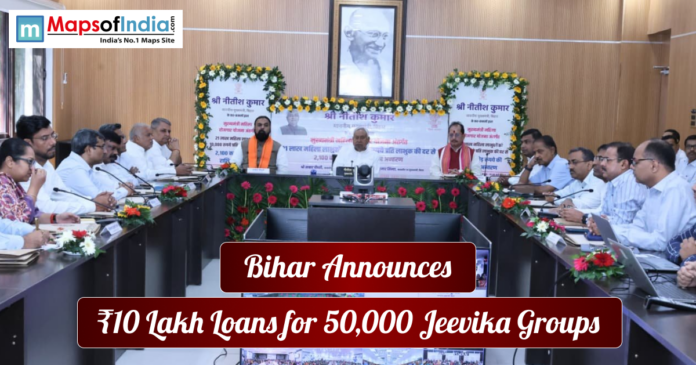 Government meeting in Bihar where officials announce ₹10 lakh loans for 50,000 Jeevika groups, with a portrait of Mahatma Gandhi displayed in the background.