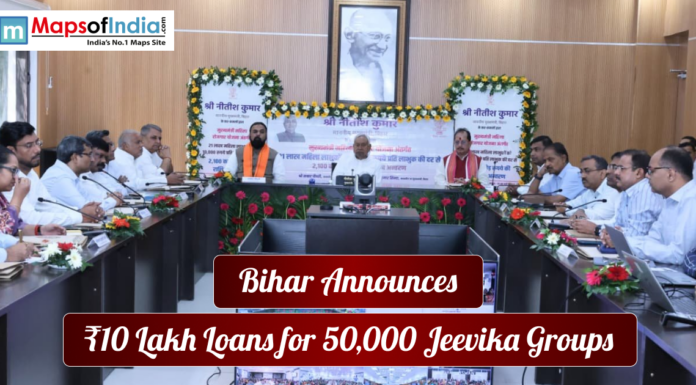 Bihar Announces ₹10 Lakh Loans for 50,000 Jeevika Groups Government meeting in Bihar where officials announce ₹10 lakh loans for 50,000 Jeevika groups, with a portrait of Mahatma Gandhi displayed in the background.