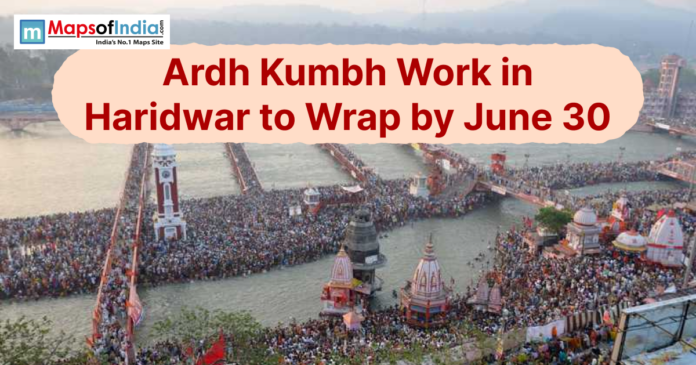 Aerial view of a crowded Har ki Pauri in Haridwar with Ardh Kumbh work update text.