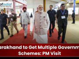 Prime Minister Narendra Modi walking on a red carpet at an event in Uttarakhand.