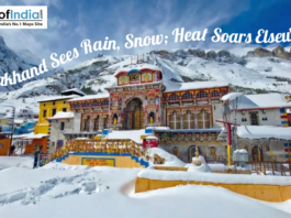 Snow-covered Badrinath Temple surrounded by Himalayan mountains as Uttarakhand experiences rain and snowfall.