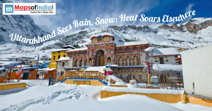 Snow-covered Badrinath Temple surrounded by Himalayan mountains as Uttarakhand experiences rain and snowfall.
