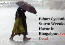 Bihar: Cyclonic Storm Wreaks Havoc in Bhagalpur, Seven Dead People walking in heavy rain with an umbrella under a headline about a cyclonic storm in Bhagalpur, Bihar.