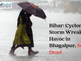 People walking in heavy rain with an umbrella under a headline about a cyclonic storm in Bhagalpur, Bihar.