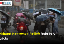 Jharkhand Heatwave Relief: Rain in 5 Districts People walking with umbrellas on a rainy street during weather relief from the Jharkhand heatwave.