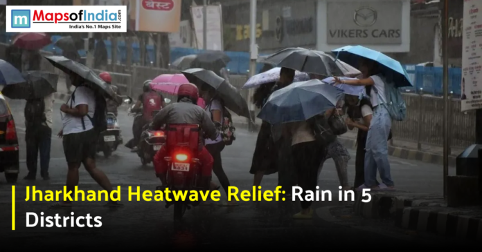 People walking with umbrellas on a rainy street during weather relief from the Jharkhand heatwave.