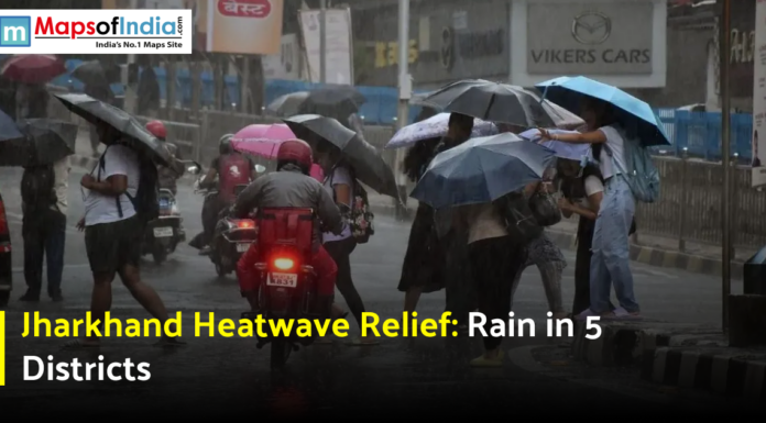 Jharkhand Heatwave Relief: Rain in 5 Districts People walking with umbrellas on a rainy street during weather relief from the Jharkhand heatwave.