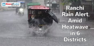 Ranchi Rain Alert Amid Heatwave in 6 Districts Auto-rickshaw driving through heavy rain on a flooded road in Ranchi with text overlay about rain alert amid heatwave in six districts.