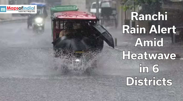 Ranchi Rain Alert Amid Heatwave in 6 Districts Auto-rickshaw driving through heavy rain on a flooded road in Ranchi with text overlay about rain alert amid heatwave in six districts.