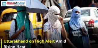 Uttarakhand on High Alert Amid Rising Heat Three people with faces covered walking outdoors under an umbrella during a heatwave.