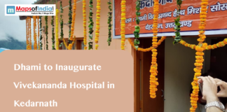 Dhami to Inaugurate Vivekananda Hospital in Kedarnath A building decorated with marigold garlands and a banner in Hindi, with text overlaying "Dhami to Inaugurate Vivekananda Hospital in Kedarnath" and the Maps of India logo.