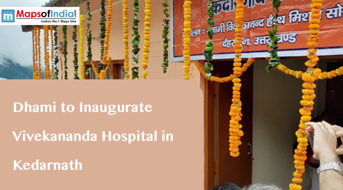 Dhami to Inaugurate Vivekananda Hospital in Kedarnath A building decorated with marigold garlands and a banner in Hindi, with text overlaying "Dhami to Inaugurate Vivekananda Hospital in Kedarnath" and the Maps of India logo.