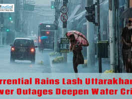 Heavy rainfall floods a city street as pedestrians use umbrellas and vehicles move through waterlogged roads in Uttarakhand