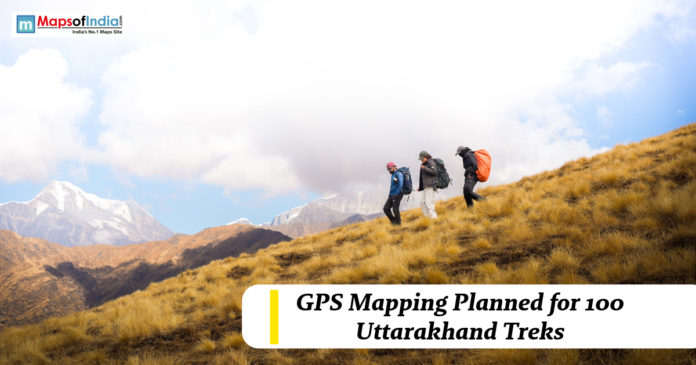 Trekkers hiking across a mountain slope in Uttarakhand with snow-capped peaks in the background, highlighting GPS mapping plans for 100 trekking routes.