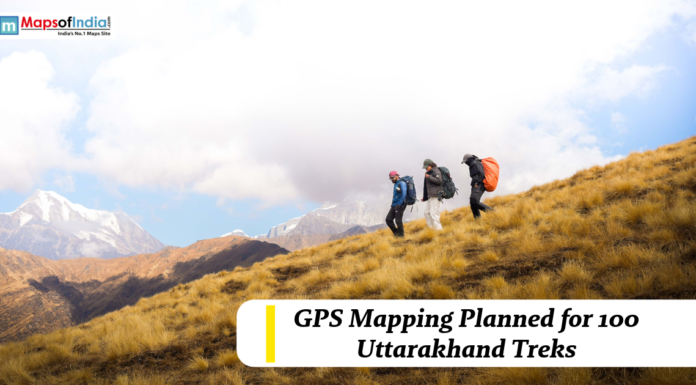 GPS Mapping Planned for 100 Uttarakhand Treks Trekkers hiking across a mountain slope in Uttarakhand with snow-capped peaks in the background, highlighting GPS mapping plans for 100 trekking routes.