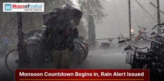 Monsoon Countdown Begins in Uttarakhand, Rain Alert Issued Heavy rainfall during monsoon season with a rain alert warning and people using umbrellas on a city street.