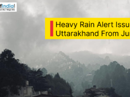 Dark rain clouds over the hills of Uttarakhand during heavy rainfall with an alert announcing heavy rain from June 11.